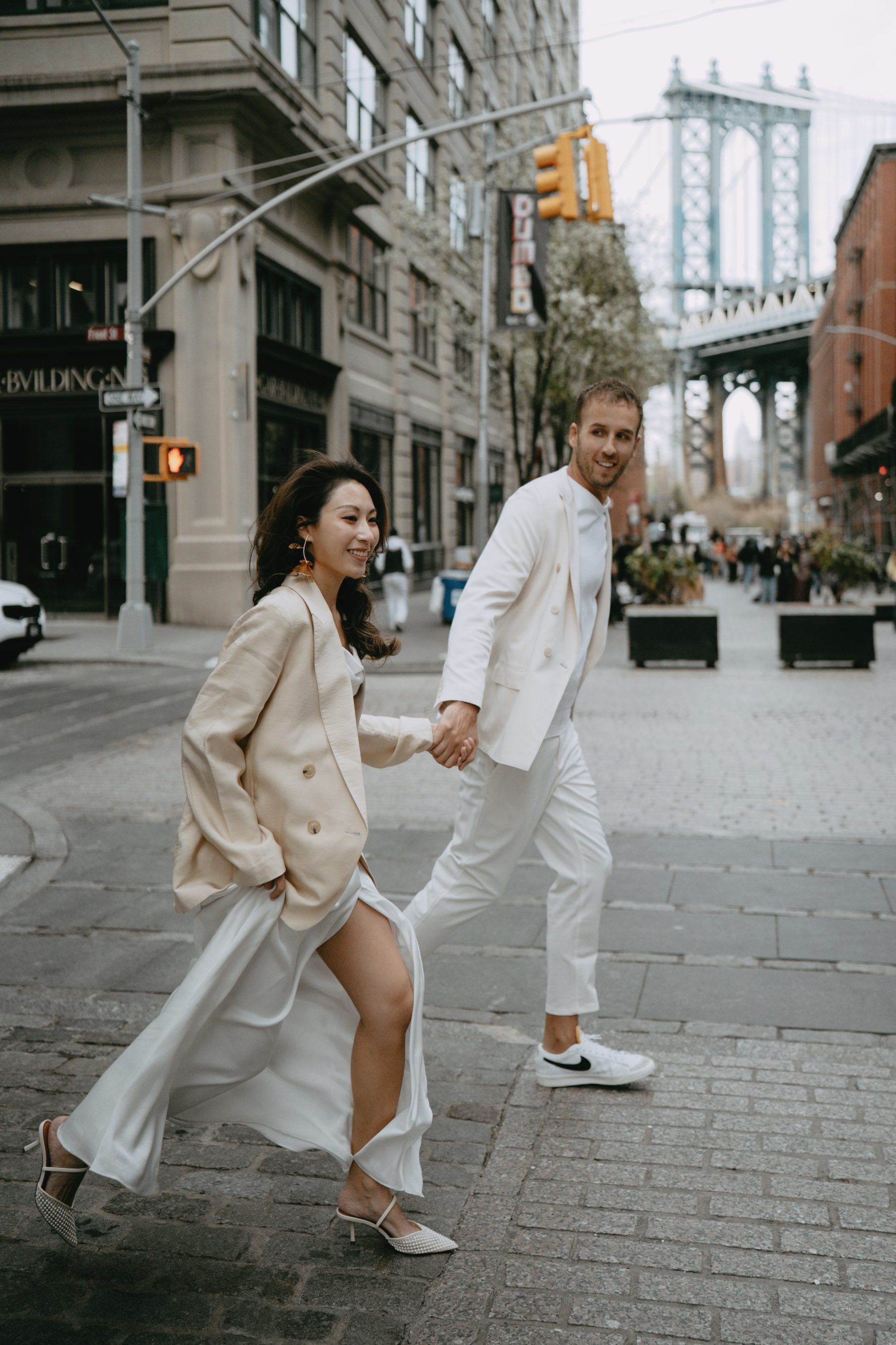Brandon and Kayla crossing a cobbled DUMBO street